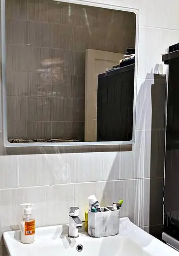 Wall mirror above the basin