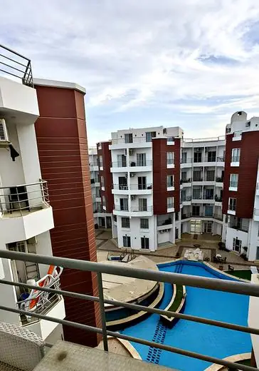 View of the pool and buildings from the kitchen balcony
