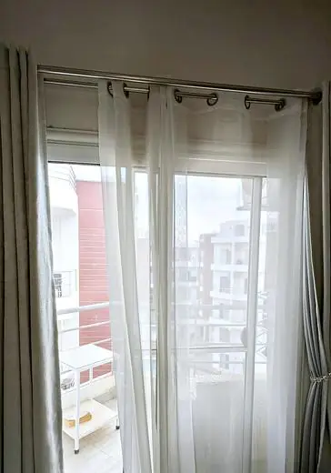 Balcony door in the living room, with curtains